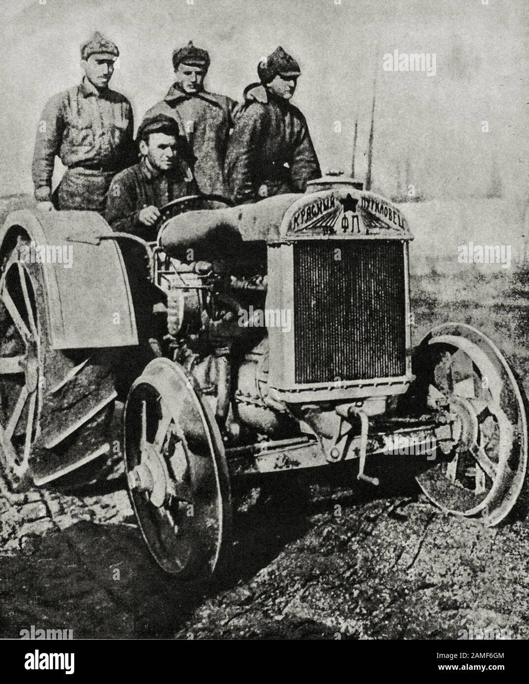 The life in Soviet Union in 1930s. From soviet propaganda book. Photo: Redarmists of the N-Georgian division learn how to drive tractors. One hundred Stock Photo