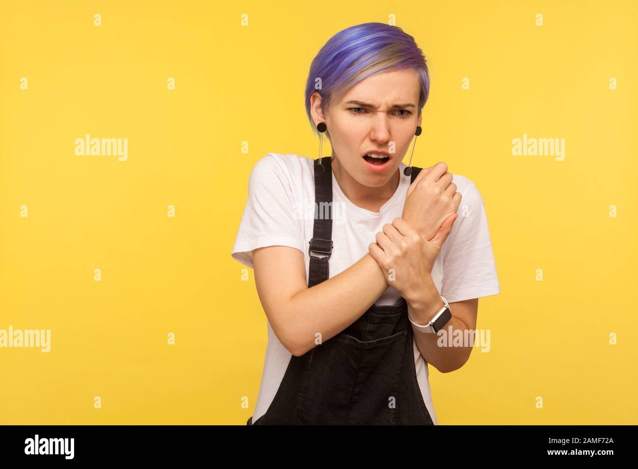 Injured hand. Portrait of unhealthy woman with violet short hair in