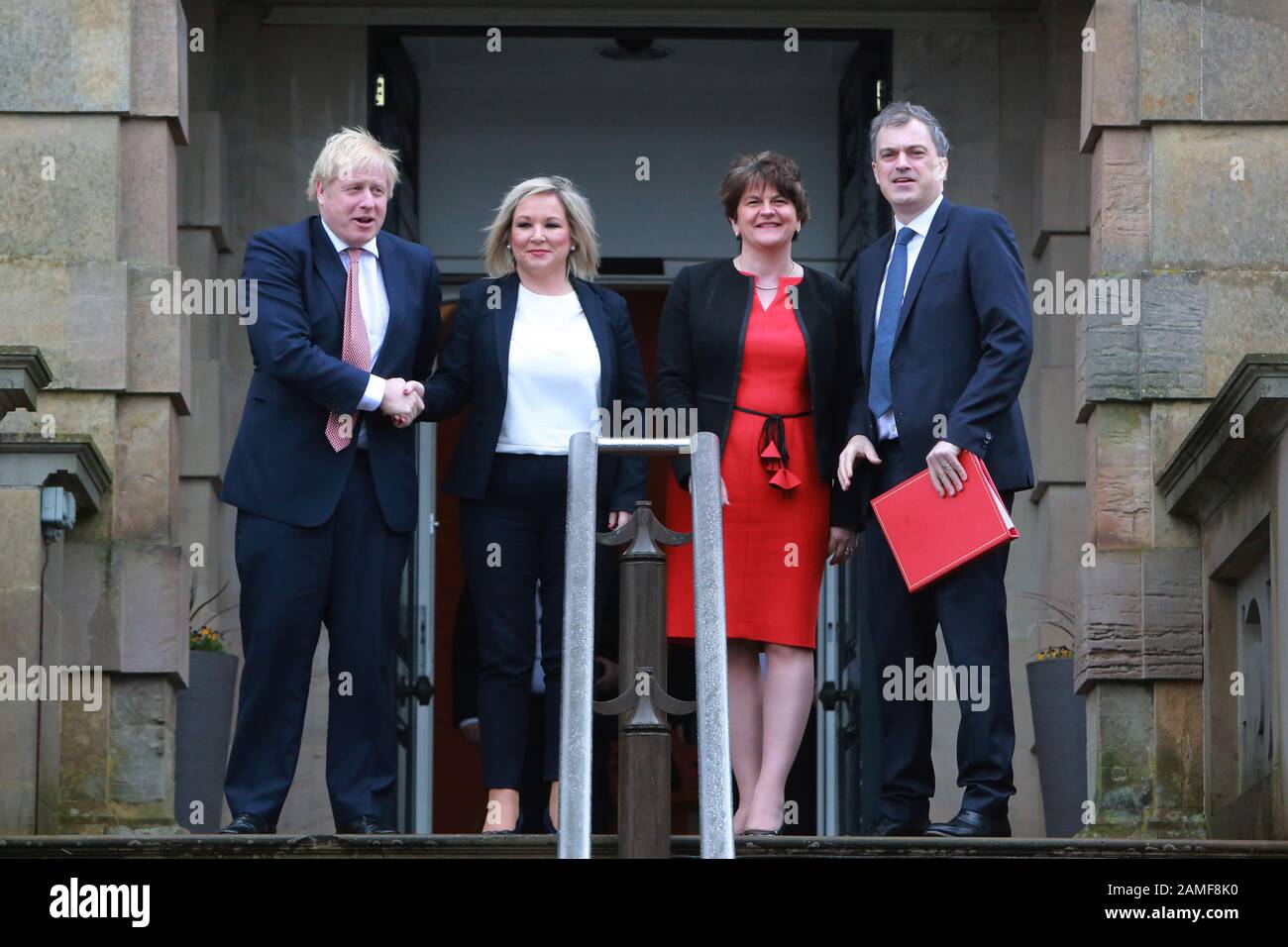 Belfast, Northern Ireland. 13th Jan 2020. British Prime Minister Boris Johnston (left) and Secretary of State for Northern Ireland Julian Smith (right) is greeted by the new Deputy First Minister Michelle O'Neill and First Minister Arlene Foster at Stormont Castle, Belfast, Northern Ireland on Jan 13, 2020. Prime Minister Boris Johnson has arrived at Stormont to mark the restoration of devolution in Northern Ireland. Taoiseach (Irish prime minister) Leo Varadkar is due later on Monday. Credit: Irish Eye/Alamy Live News Stock Photo
