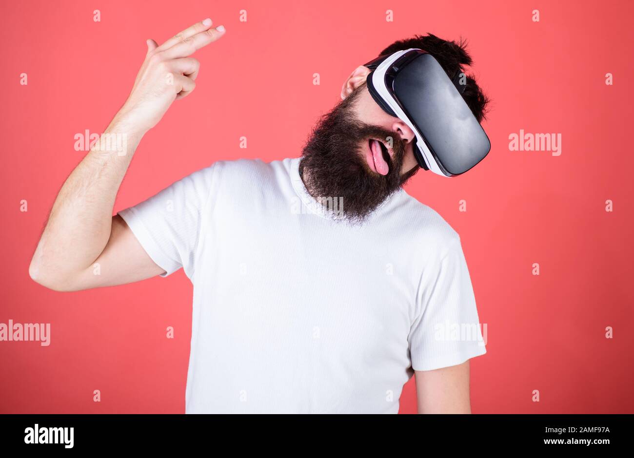 First person shooter shows how addictive VR could be. Suicide shot game. Man  hand gesture as gun play shooter game in VR glasses. Man bearded hipster  with virtual reality headset on red