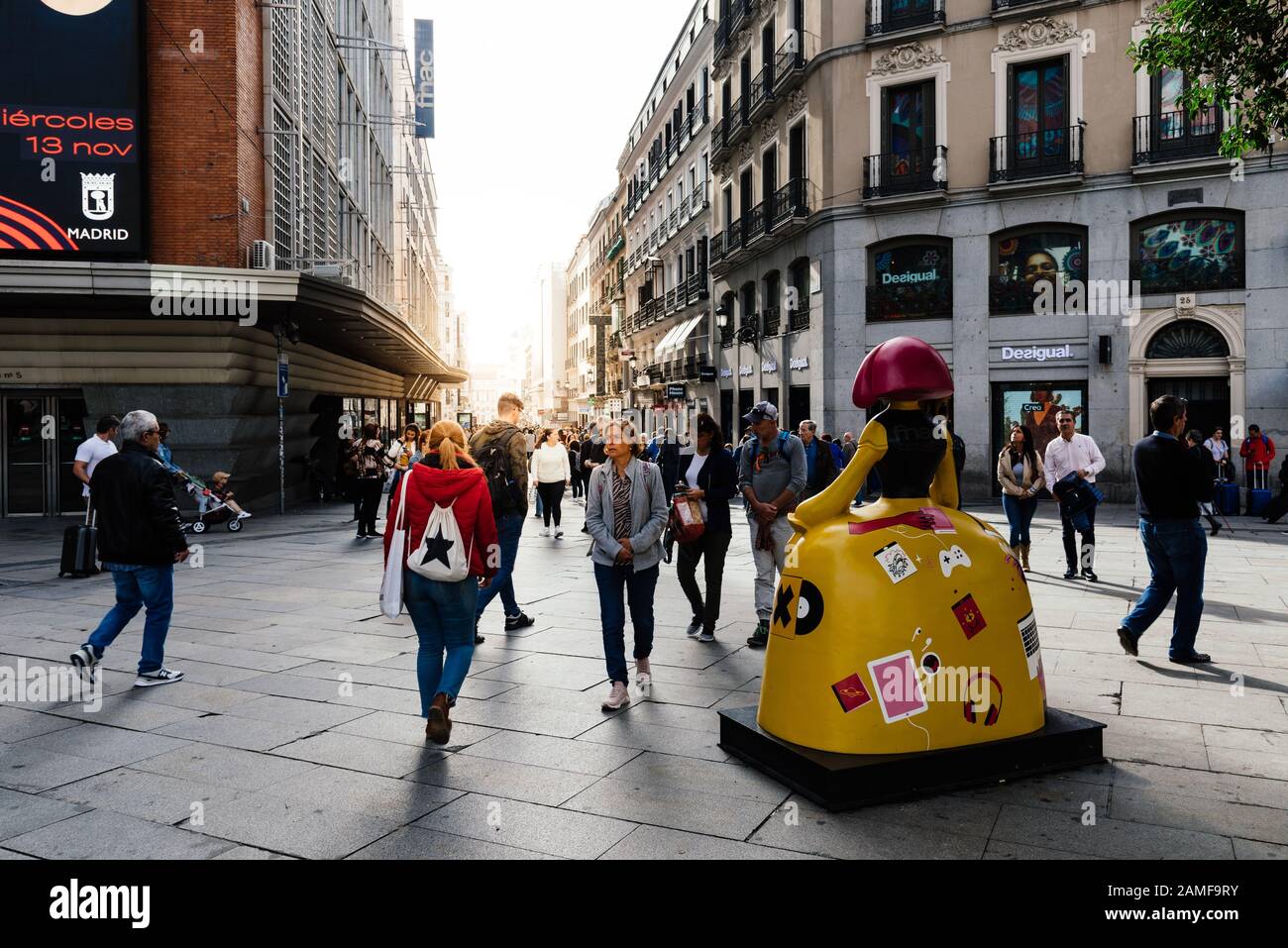 Madrid, Spain - November 1, 2019: People in Callao Square and Preciados commercial street with sun flare on background. Madrid, Spain Stock Photo