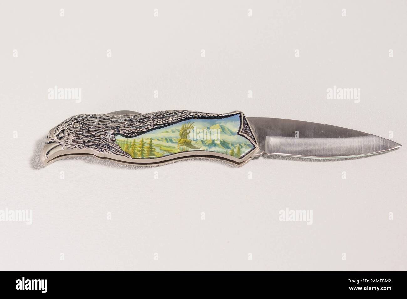 a knife with bird shaped handle and ceramic inlay Stock Photo