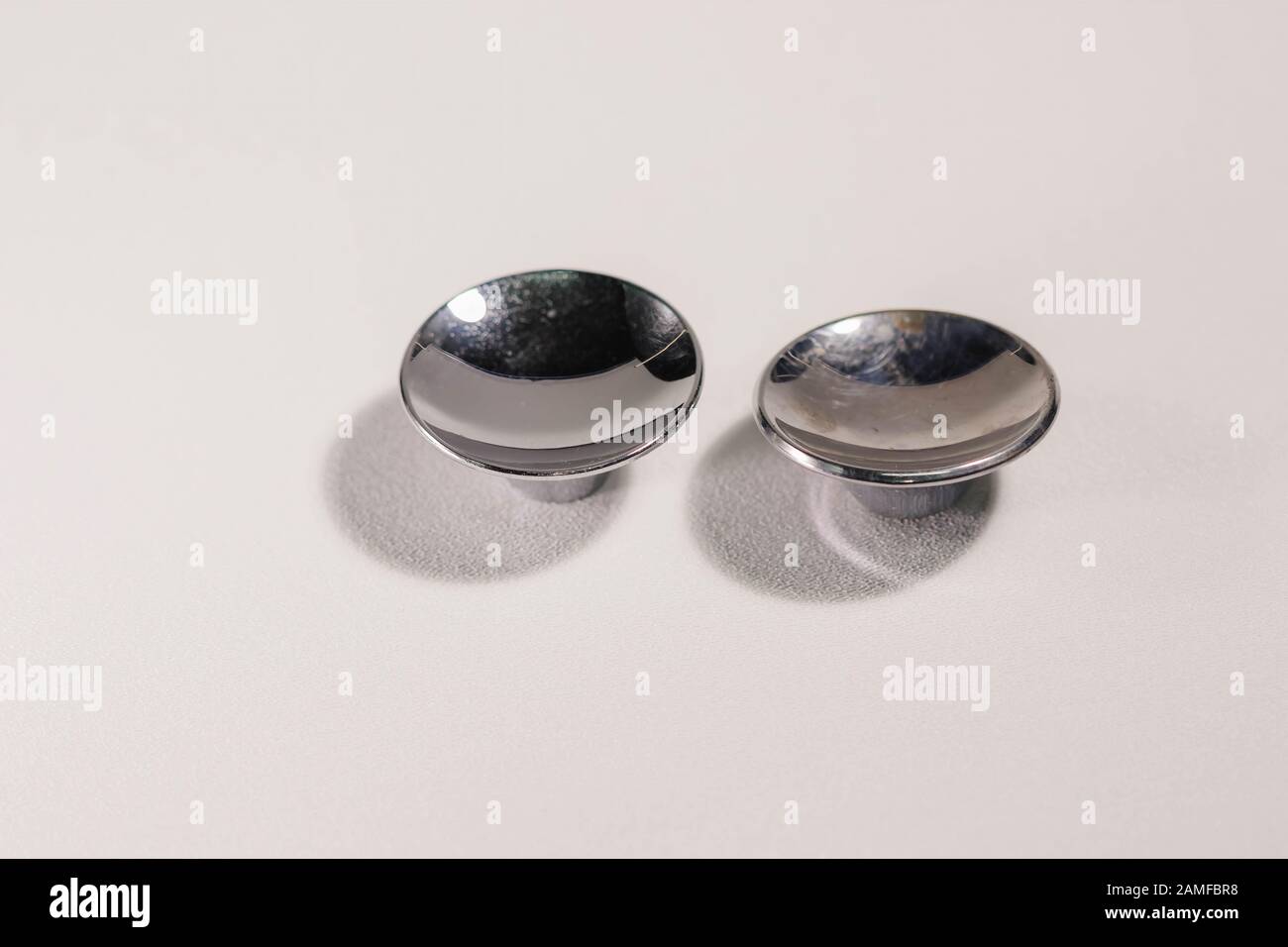 Two Silver Colored Metal Drawer Knobs Of Two Different Sizes Stock