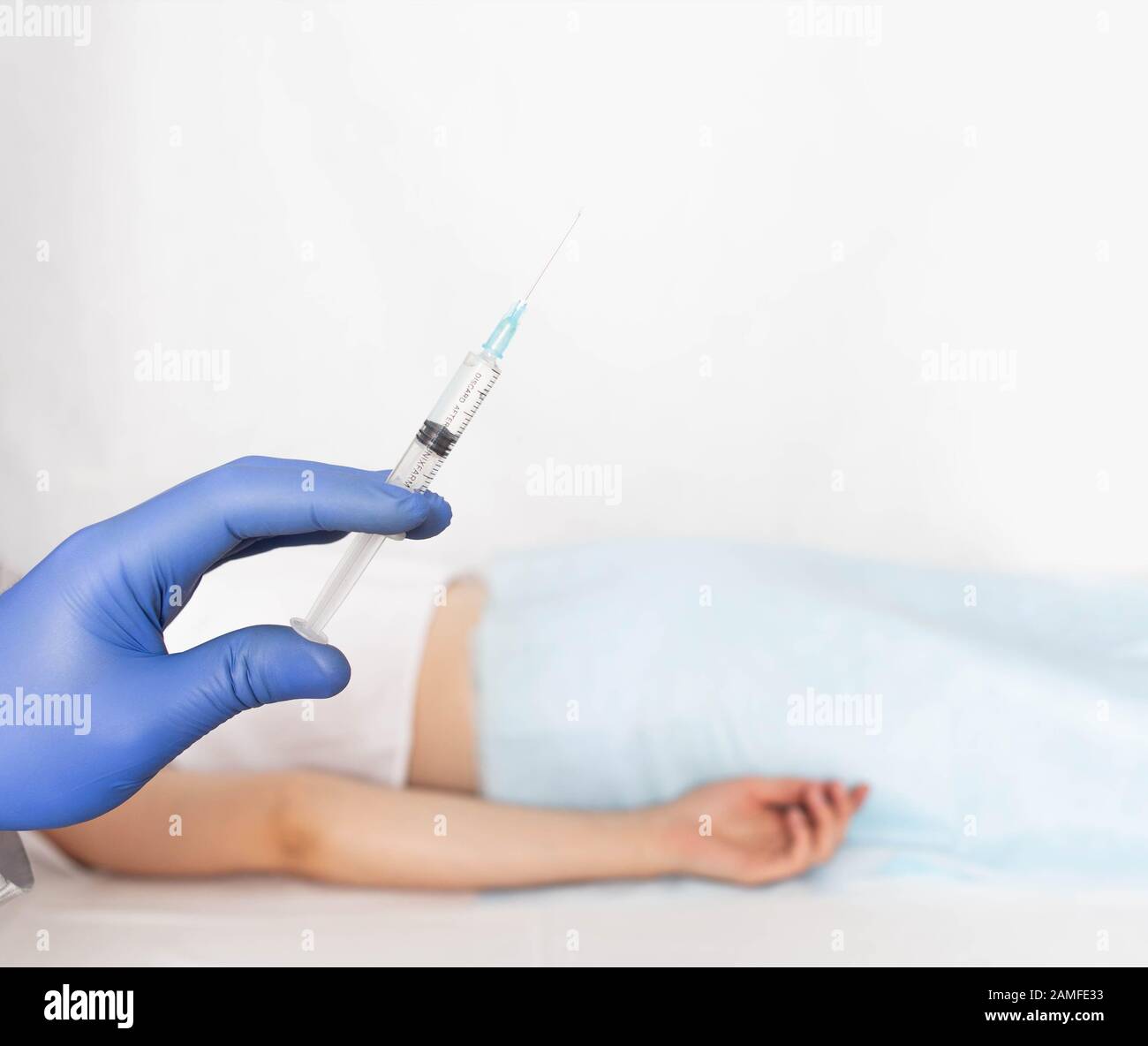The doctor holds a syringe in a glove against the background of a patient with varicose veins and hemorrhoids. Sclerotherapy treatment concept, copy s Stock Photo