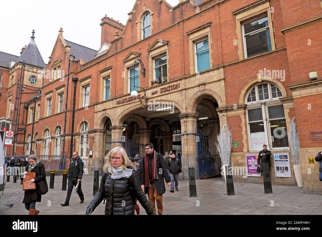 Commuters passengers people on their way to work leaving Marylebone Station outside entrance on a winter morning in London NW1 England UK KATHY DEWITT Stock Photo