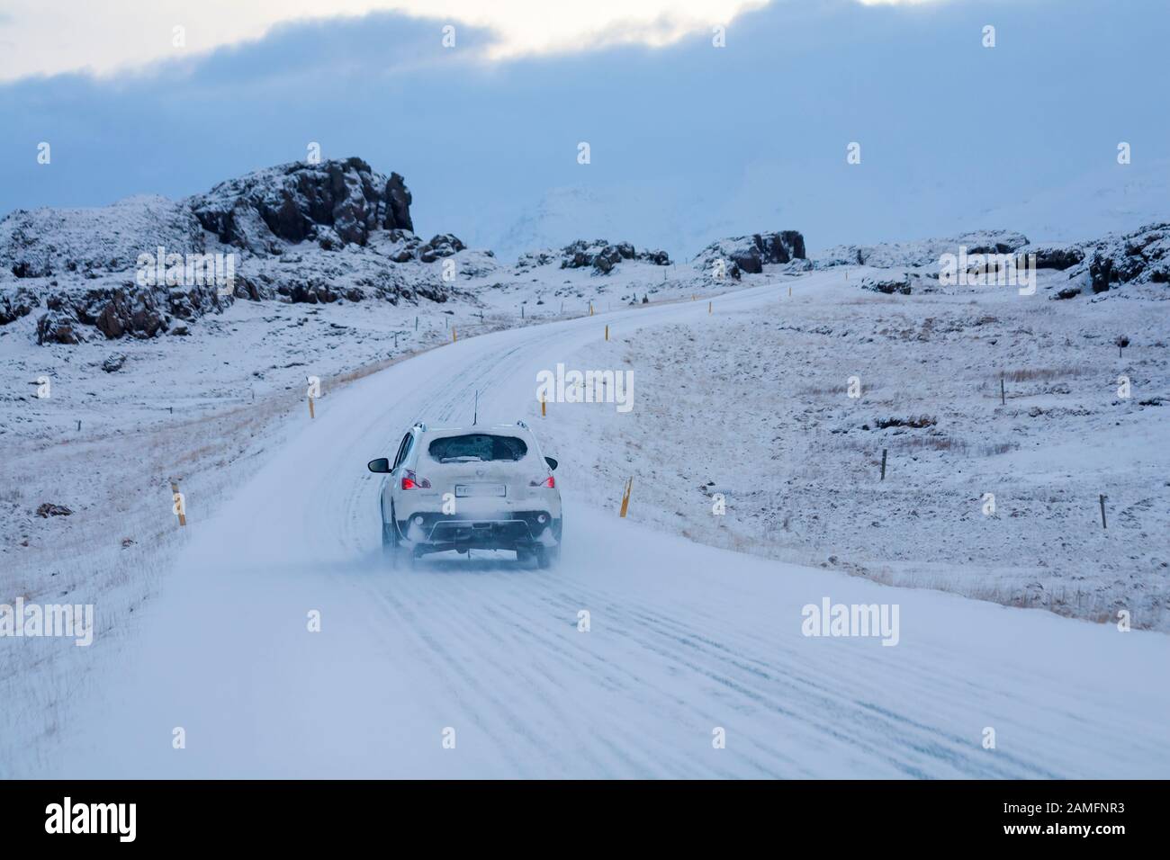 car driving along road in snowy conditions in Iceland in January Stock Photo