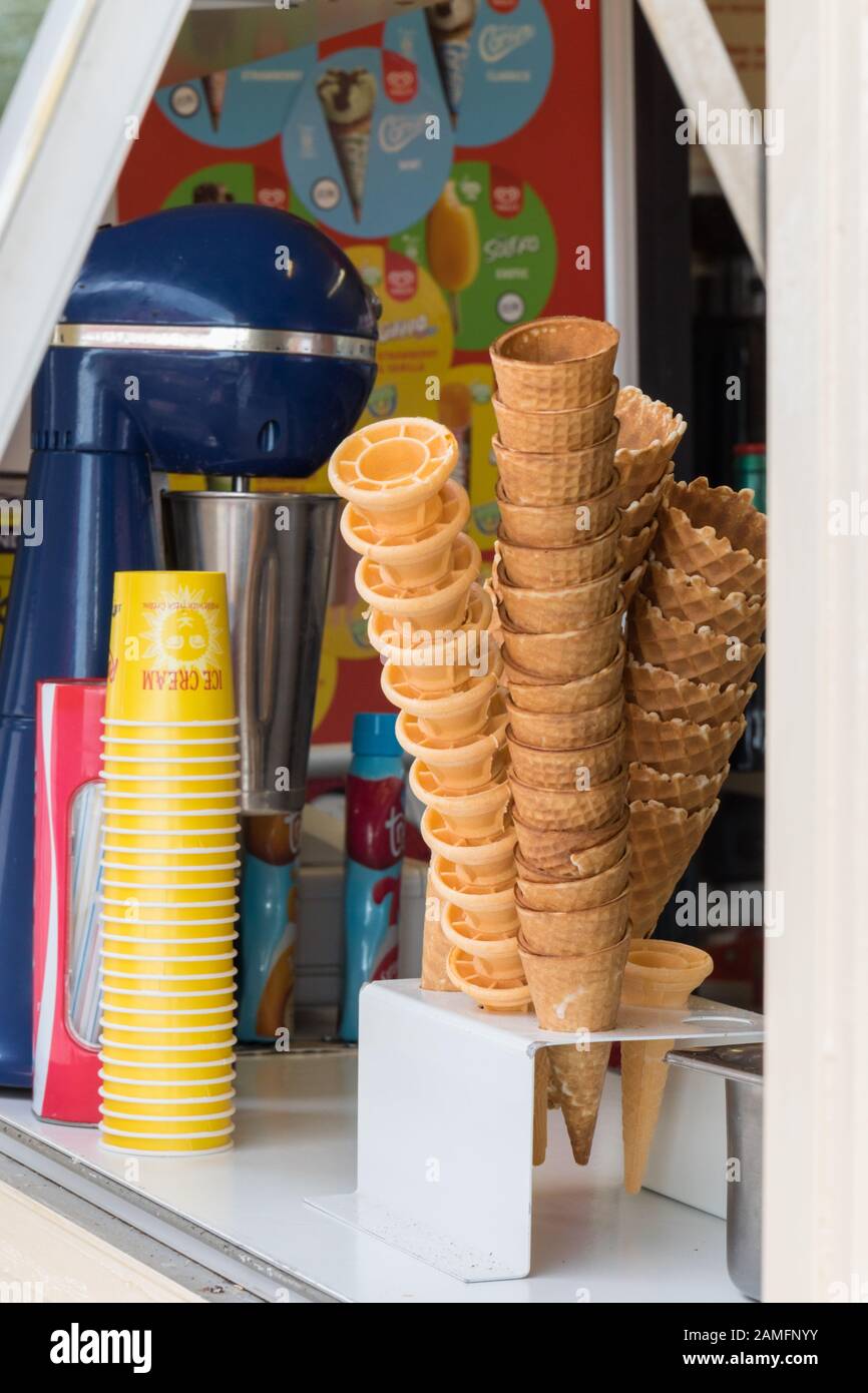 Empty ice cream cones and tubs stacked up on display ready for sale on
