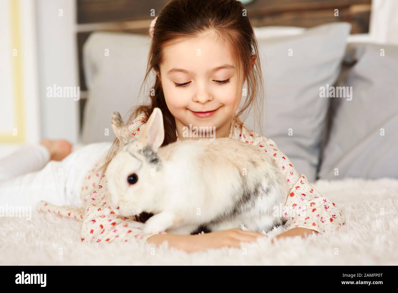 Affectionate girl playing with rabbit Stock Photo Alamy