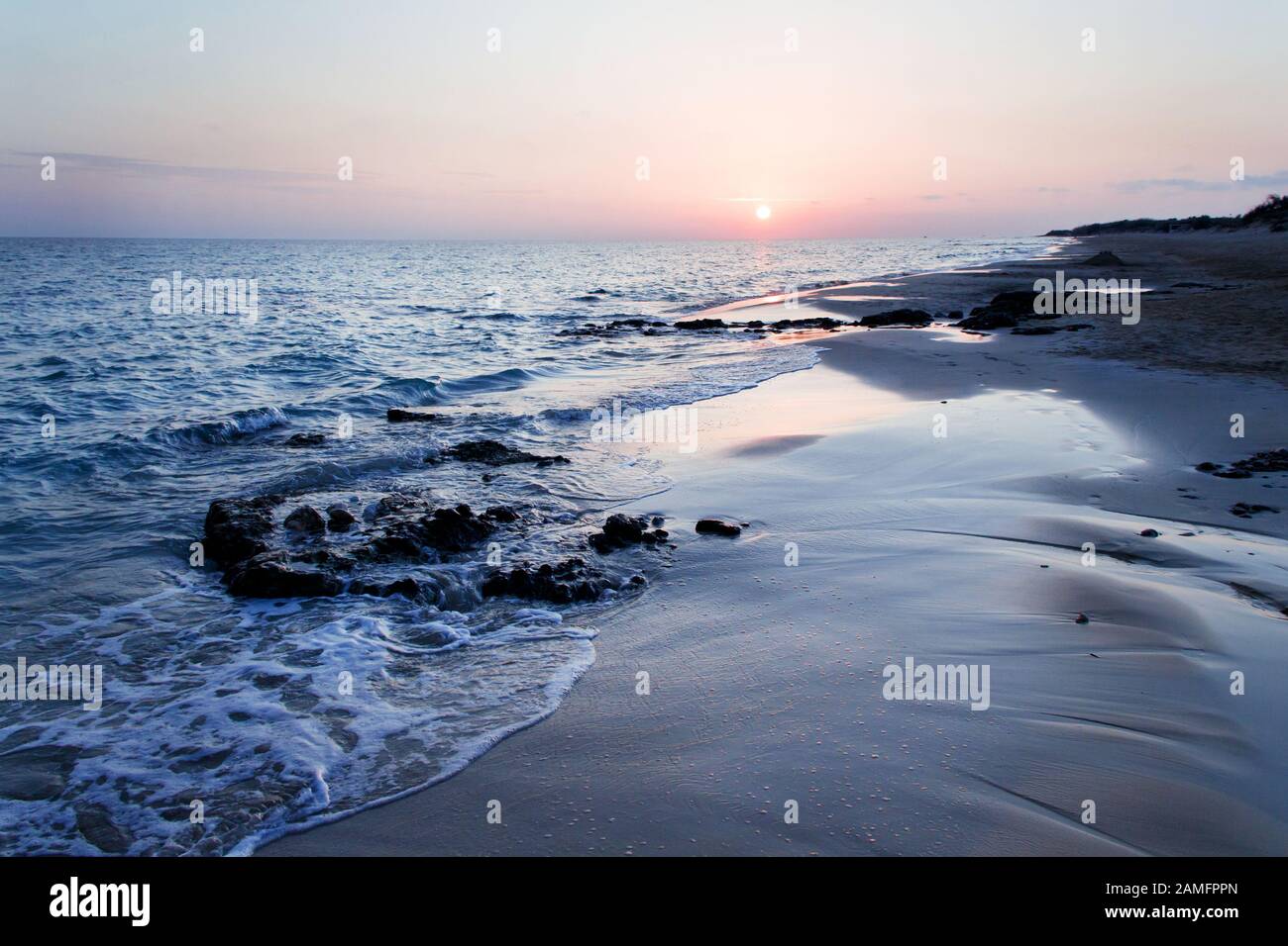 Sunset on the Pescoluse beach, Apulia, Italy Stock Photo - Alamy