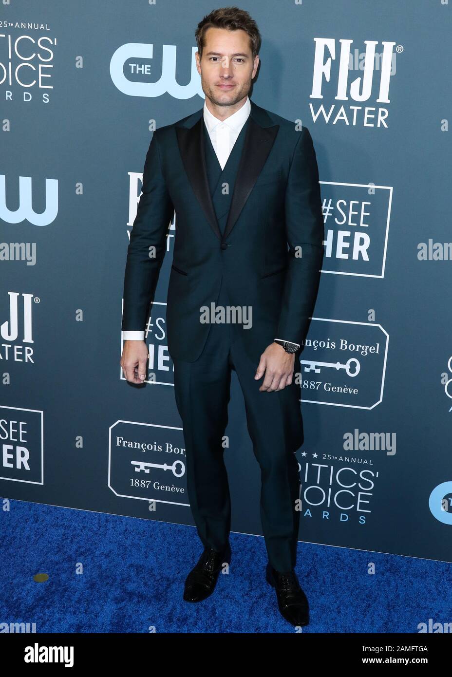 Santa Monica Los Angeles California Usa January 12 Actor Justin Hartley Wearing An Isaia Tux Christian Louboutin Shoes And An Omega Watch And Cuff Links Arrives At The 25th Annual Critics