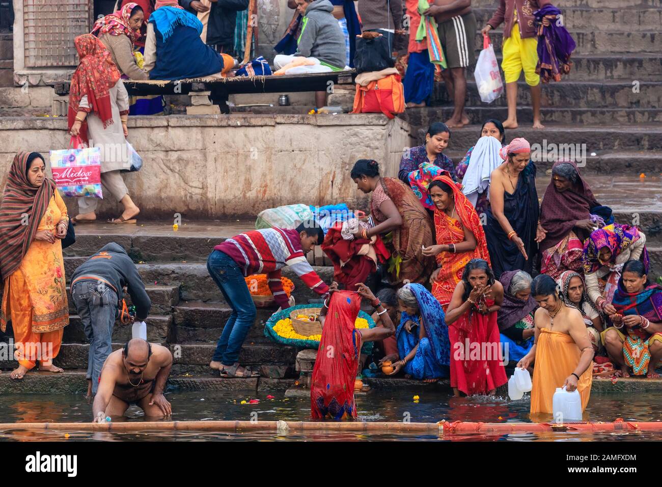VARANASI, INDIA, JANUARY 18, 2019 : Traditional Ganges river bathing and Hindu ritual at sunrise along the Varanasi Ghats Stock Photo