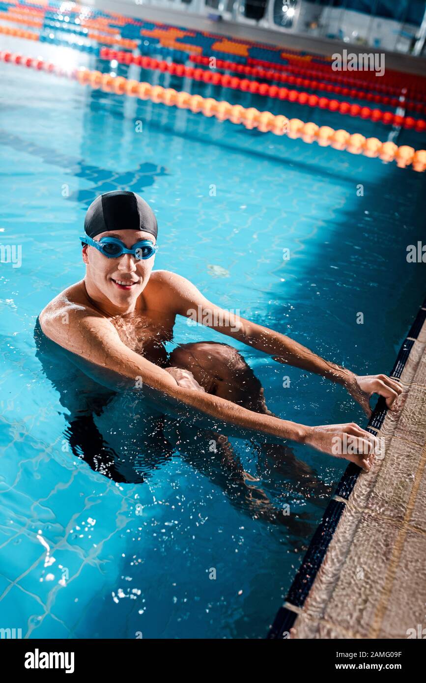CAL: Releases - Page 5 Happy-swimmer-in-goggles-smiling-while-looking-at-camera-in-swimming-pool-2AMG09F