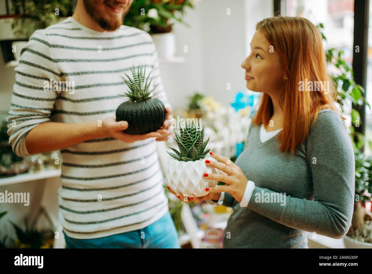 Young smiling people florists working in the home Stock Photo