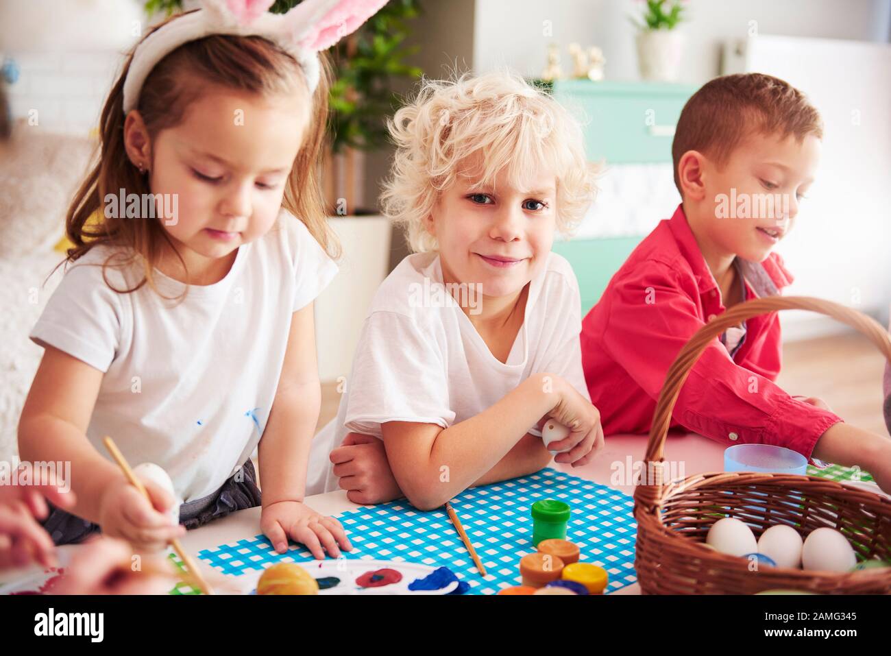 Happy kids start decorating easter eggs Stock Photo