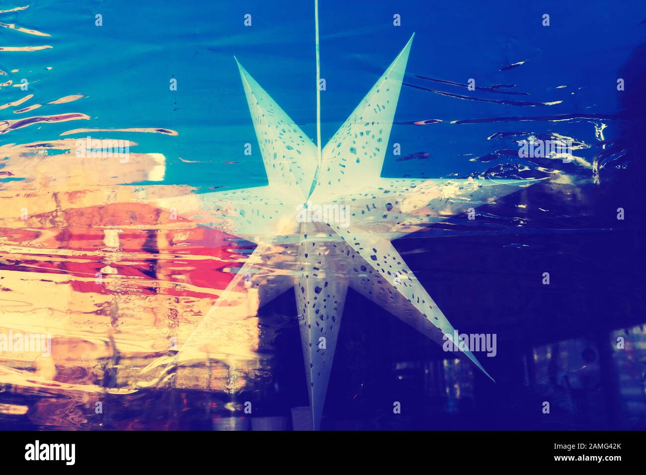 Paper star on the window with reflection Stock Photo