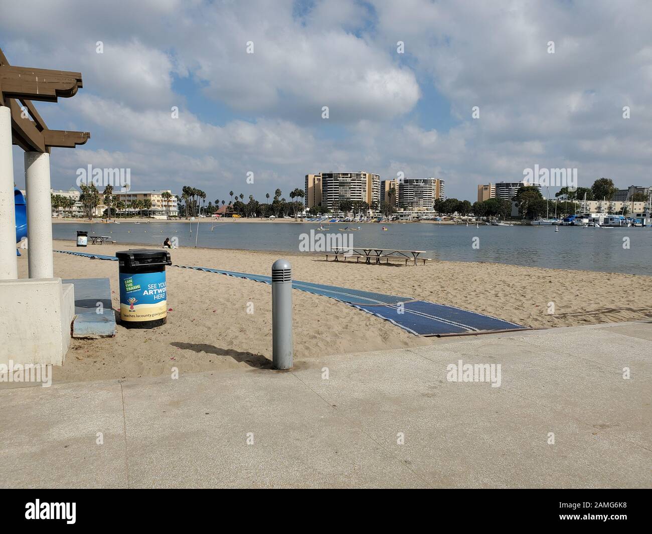 Beach path entrance is visible at Mother's Beach, aka Marina Beach, in Marina Del Rey, Los Angeles, California, October 27, 2019. The temporary paths allow beach access for visitors with strollers, or disabled persons with wheelchairs. () Stock Photo