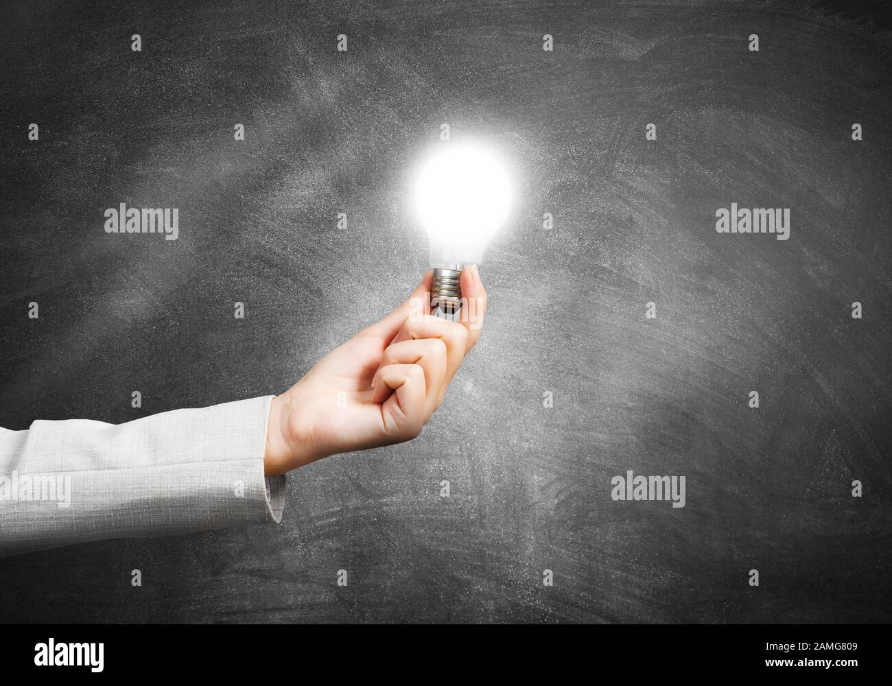 Woman hand holding glowing light bulb Stock Photo - Alamy