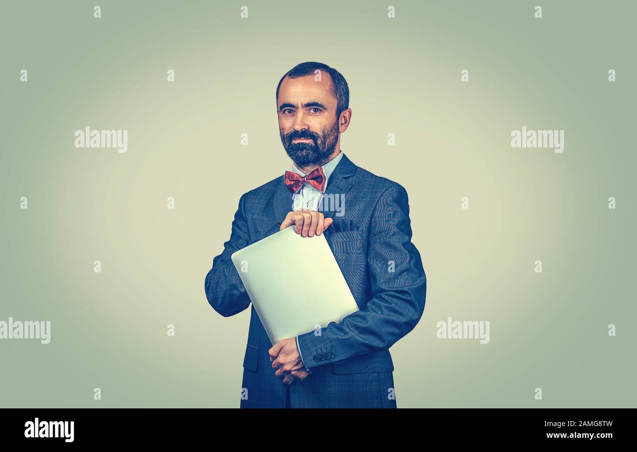 Neutral Elegant Standing Beard Man With Laptop Computer Looking
