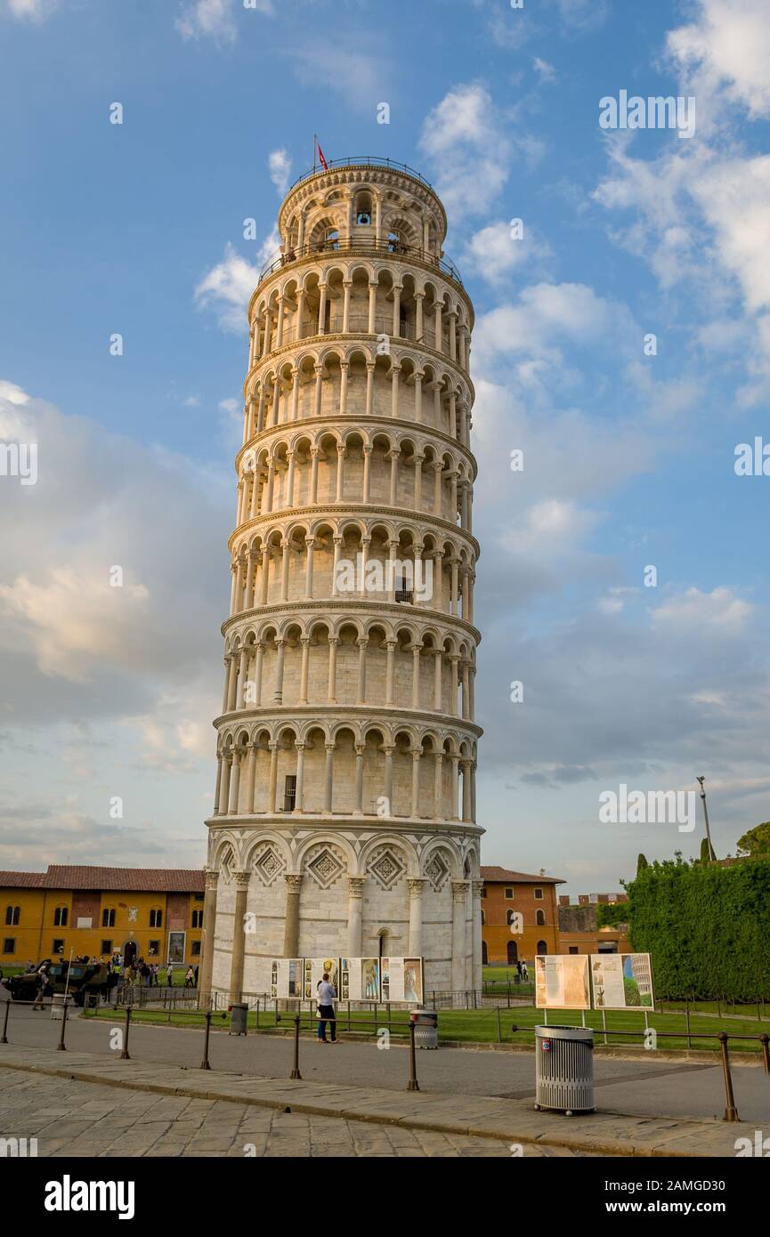 Pisa tower vertical view and light clouds at blue sky. Evening at Pisa, Italy. Stock Photo