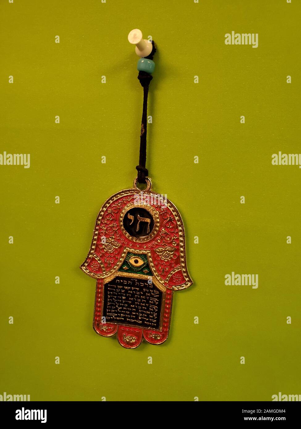 Close-up of traditional Jewish Chamsa, a charm worn to combat the Evil Eye in Jewish mysticism (Kaballah), on a light green background, November 18, 2019. () Stock Photo