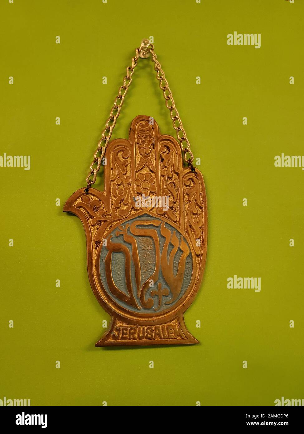 Close-up of traditional Jewish Chamsa, a charm worn to combat the Evil Eye in Jewish mysticism (Kaballah), on a light green background, November 18, 2019. () Stock Photo