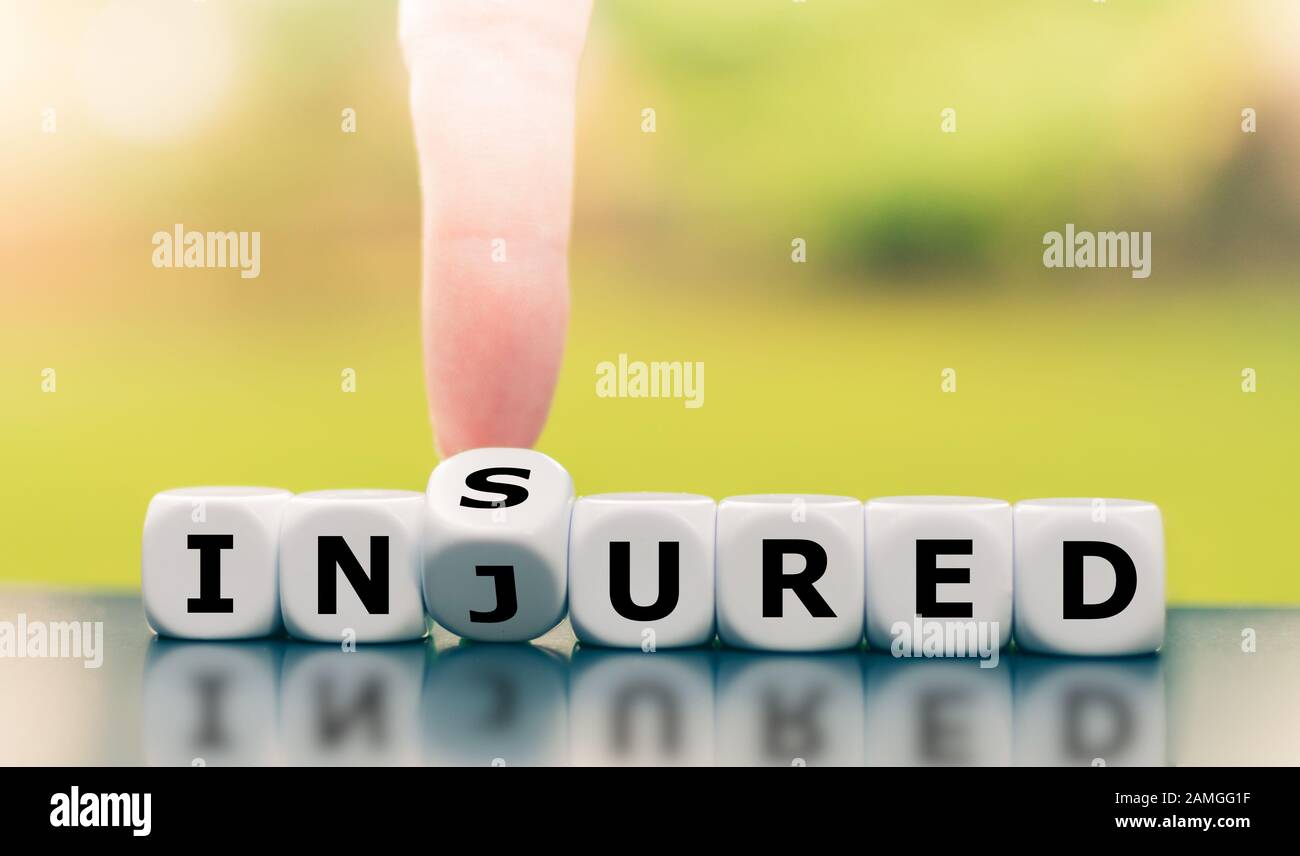 Be Insured When Injured Hand Turns A Dice And Changes The Word Injured To Insured Stock Photo Alamy