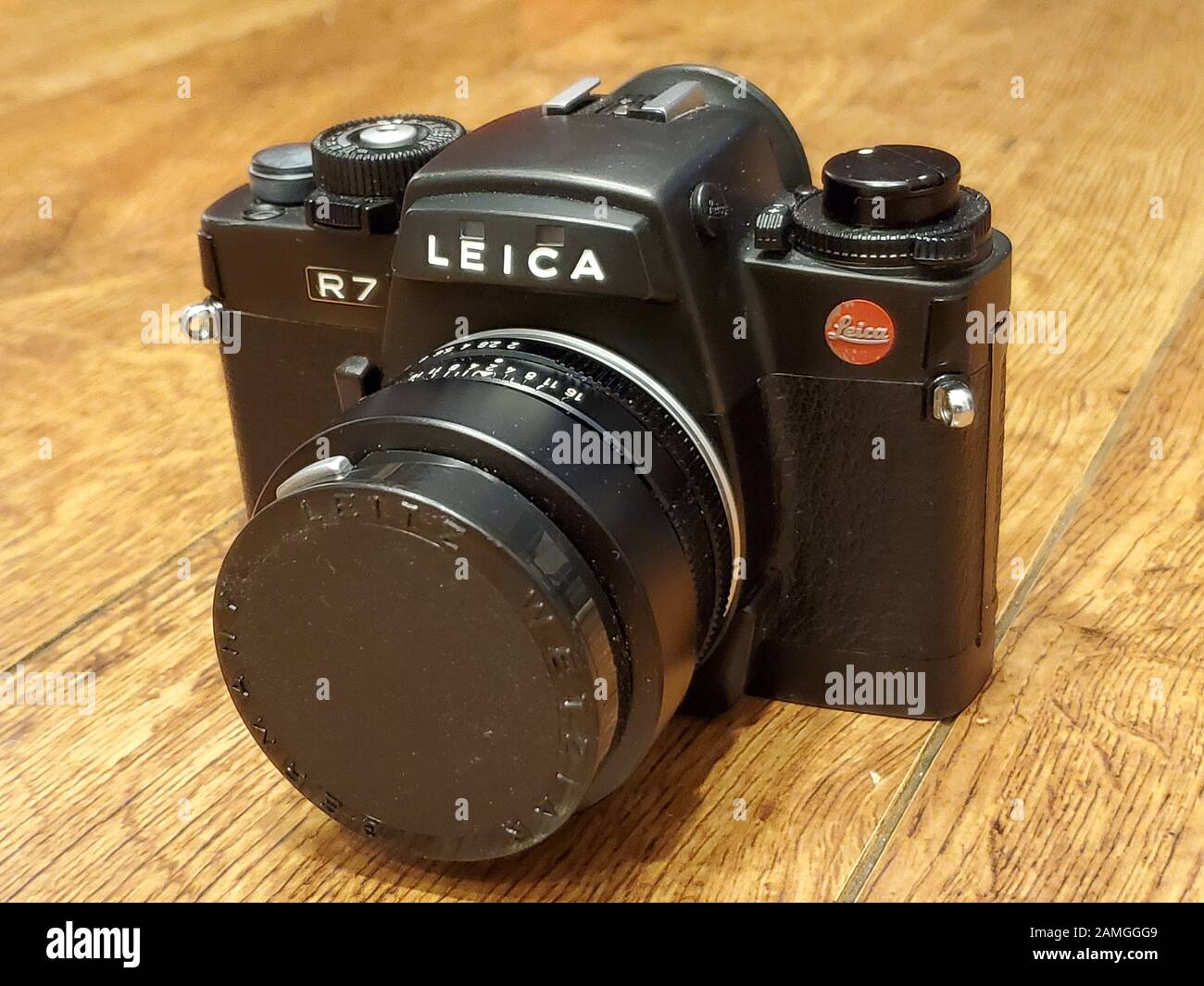 Close-up of Leica R7 film camera with 50mm prime lens on light wooden surface, November 27, 2019. () Stock Photo
