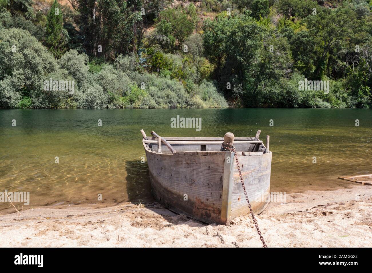Wooden boat by the river Stock Photo - Alamy