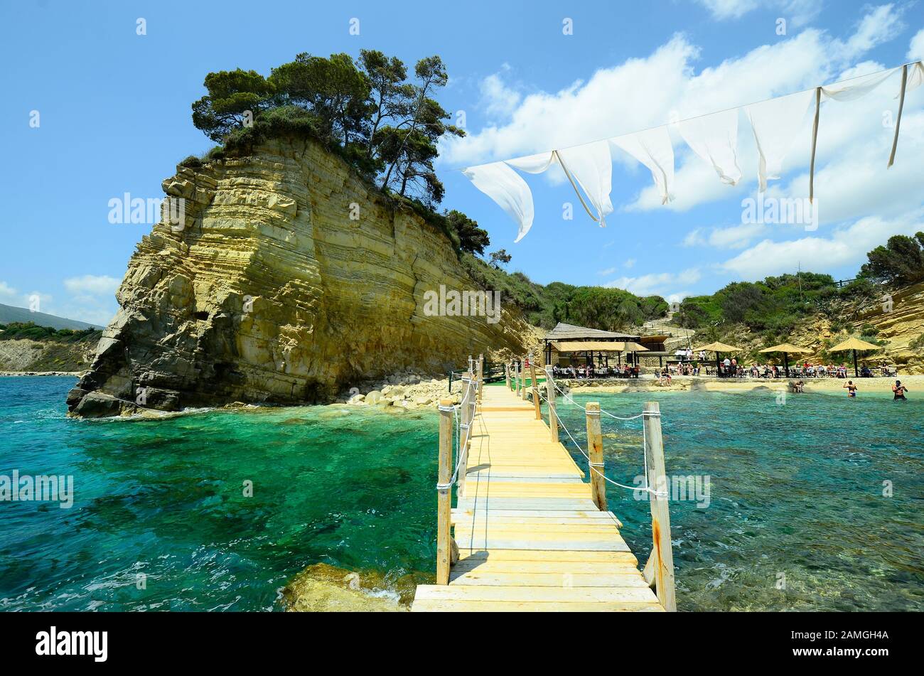 Zakynthos, Greece - May 24th 2016: Unidentified people on beach of tiny Cameo island with bar-restaurant in Ionian sea Stock Photo