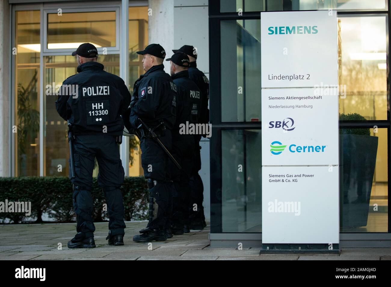 Hamburg, Germany. 13th Jan, 2020. Policemen are standing in front of the entrance in front of the Hamburg Siemens office. Here a protest action of climate activists of Fridays for Future took place. In response to the Siemens decision to supply technology for a controversial coal mine project in Australia, the demonstrators had agreed to rallies at various locations in Germany. Despite all criticism, the Munich-based industrial concern wants to stick with an order for a giant coal mine. Credit: Christian Charisius/dpa/Alamy Live News Stock Photo