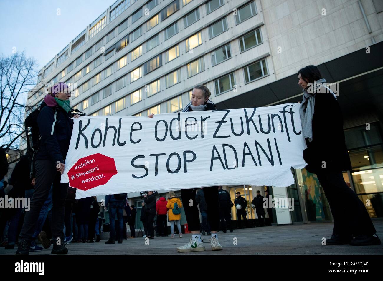 Hamburg, Germany. 13th Jan, 2020. Climate activists demonstrate during a Fridays for Future protest action in front of the Siemens office in Hamburg. The banner says 'Coal or future - Stop Adani'. In response to the Siemens decision to supply technology for a controversial coal mine project in Australia, the demonstrators had agreed to rallies at various locations in Germany. Despite all criticism, the Munich-based industrial concern wants to stick with an order for a giant coal mine. Credit: Christian Charisius/dpa/Alamy Live News Stock Photo