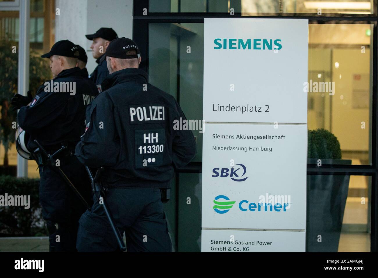 Hamburg, Germany. 13th Jan, 2020. Policemen are standing in front of the entrance in front of the Hamburg Siemens office. Here a protest action of climate activists of Fridays for Future took place. In response to the Siemens decision to supply technology for a controversial coal mine project in Australia, the demonstrators had agreed to rallies at various locations in Germany. Despite all criticism, the Munich-based industrial concern wants to stick with an order for a giant coal mine. Credit: Christian Charisius/dpa/Alamy Live News Stock Photo