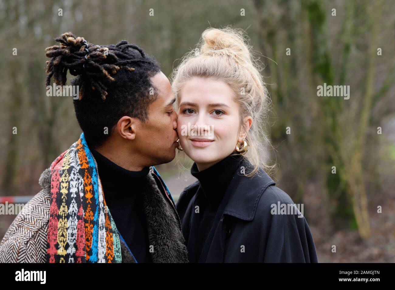 Young intercultural caucasian-hispanic student couple during a winter walk in Bottrop, Germany. Stock Photo