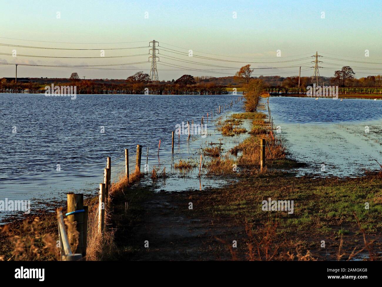 On the West Lancashire plain below Parbold Hill agricultural fields and fences off Mains Lane, Burscough have become flooded in the winter rains. Stock Photo