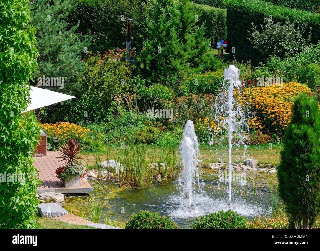 pond with water fountains in a summerly garden Stock Photo