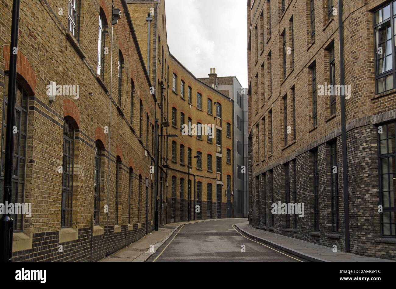 Historic, narrow street in Southwark, London.  Valentine Place has existed since the 18th century and was overtaken by the current warehouse and facto Stock Photo