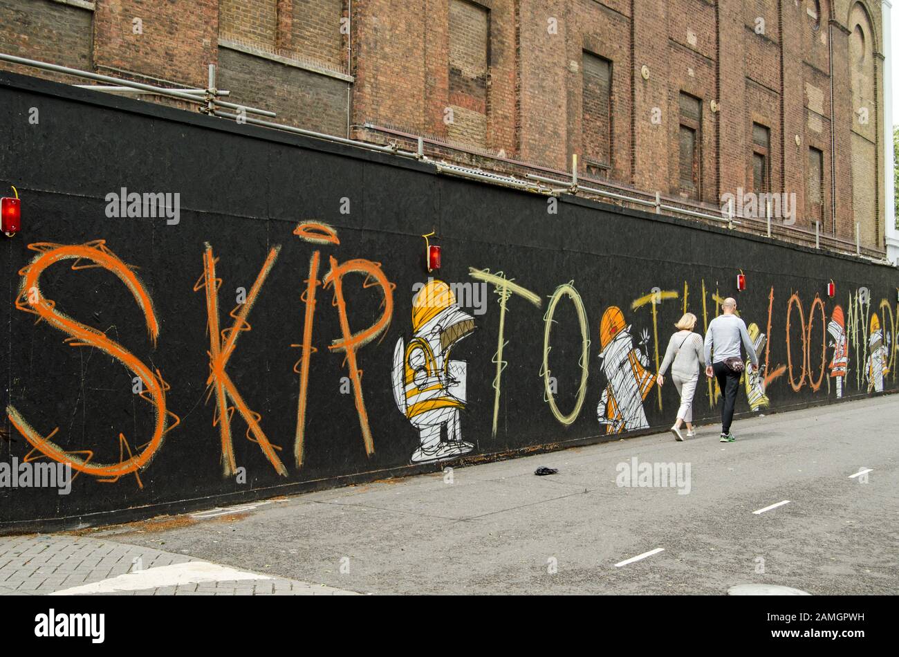 London, UK - July 20, 2019: A hoarding decorated with figures and lettering by the street artist Nathan Bowen next to the Old Vic Theatre in Lambeth, Stock Photo