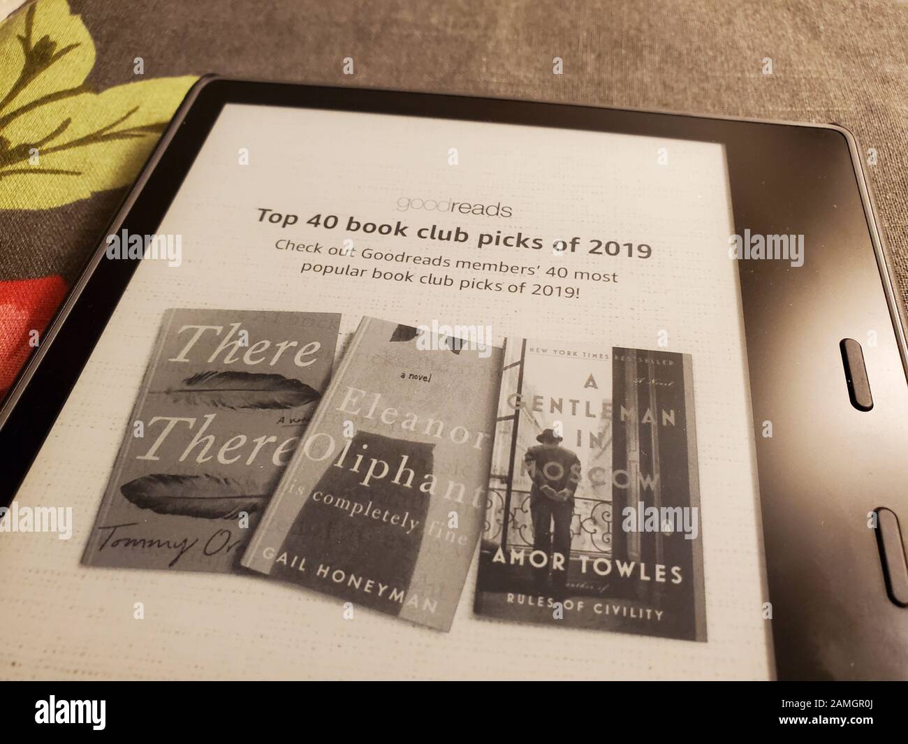 Close-up of latest generation Amazon Kindle Oasis e book reader with leather cover on floral print fabric, San Ramon, California, January 2, 2020. () Stock Photo