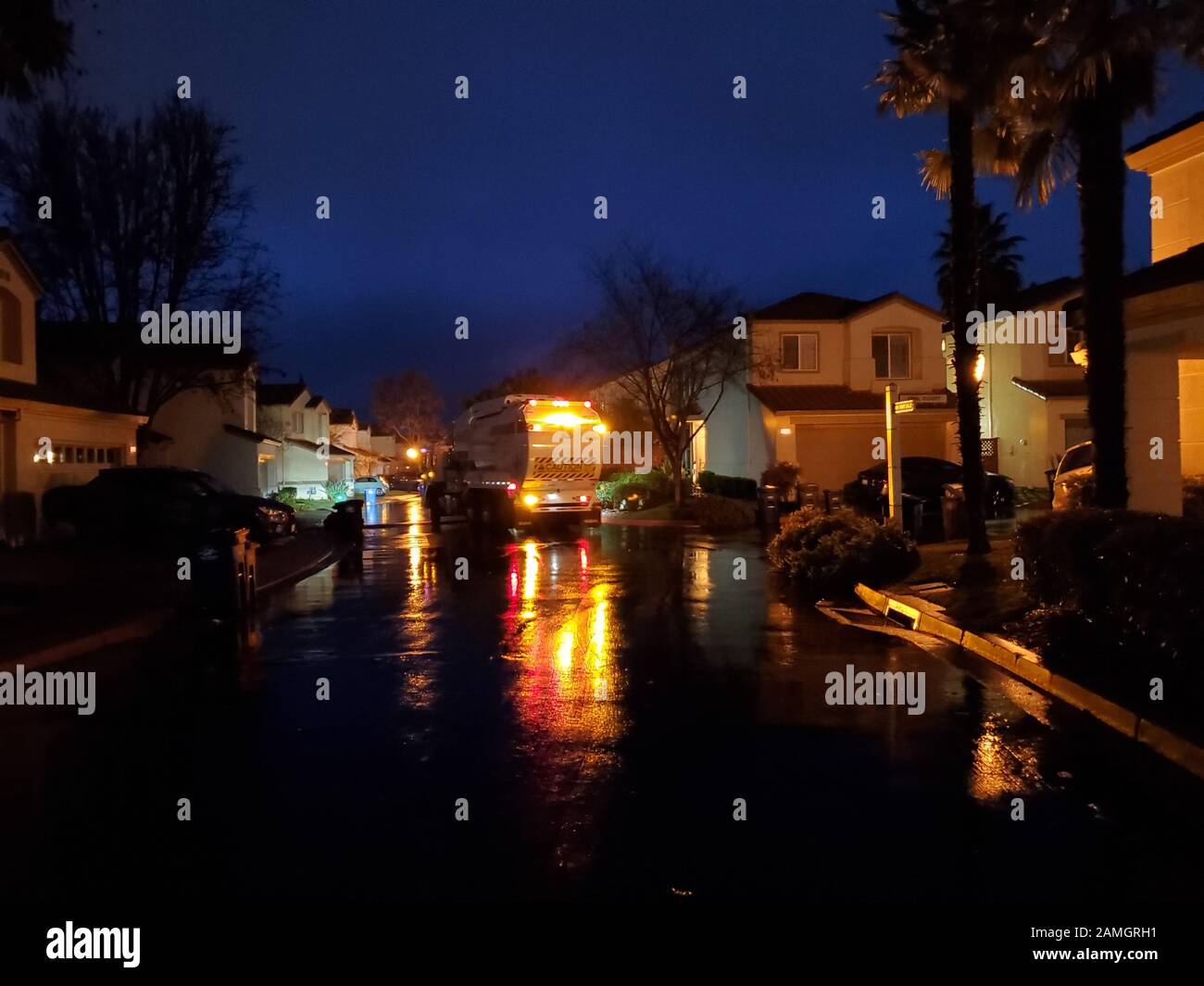 Trash truck or recycling truck at night in a suburban neighborhood in the San Francisco Bay Area, San Ramon, California, January 9, 2020. () Stock Photo