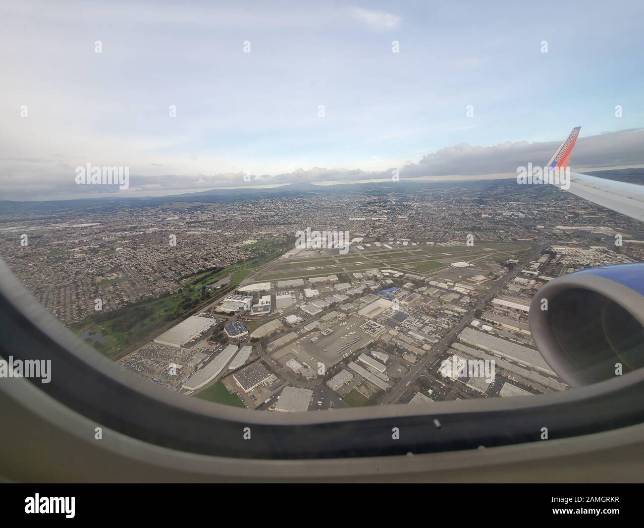 Wide angle view out window of Southwest Airlines aircraft, with wingtip visible, flying over Oakland, California, January 8, 2020. () Stock Photo