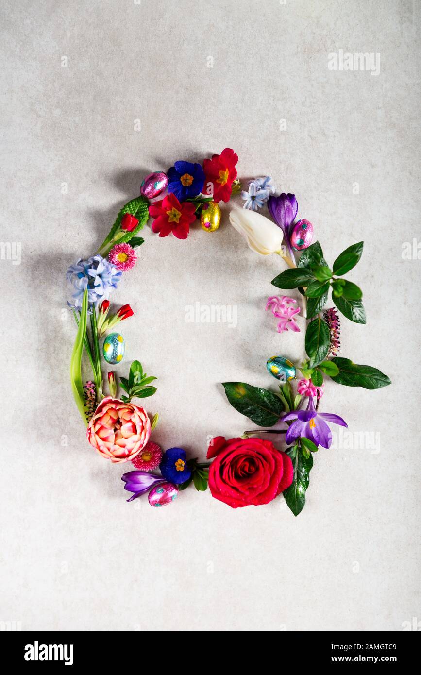 Easter minimal concept. Egg shape made from spring flowers on grey ...