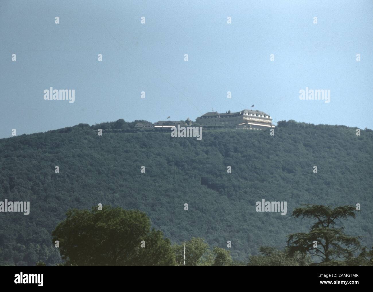 Vernacular photograph taken on a 35mm analog film transparency, believed to depict white building on top of mountain, 1965. Major topics/objects detected include Sky, Hill, Sea, Mountain, Nature and Gray Color. () Stock Photo