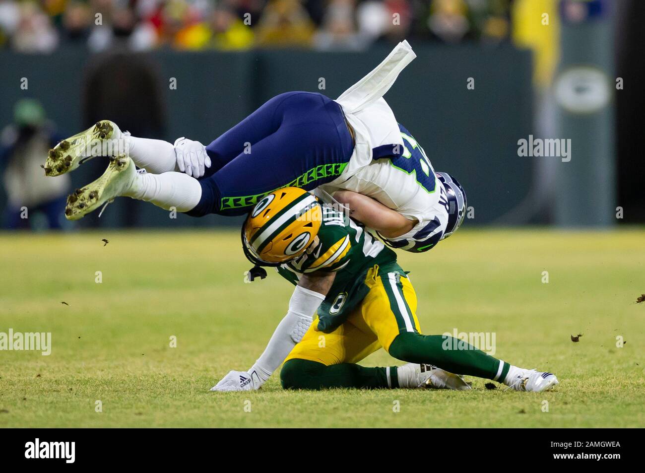 Green Bay, USA. 12th Jan, 2020. January 12, 2020: Green Bay Packers  cornerback Jaire Alexander #23 upends Seattle Seahawks tight end Jacob  Hollister #48 in the first quarter of the NFL Football