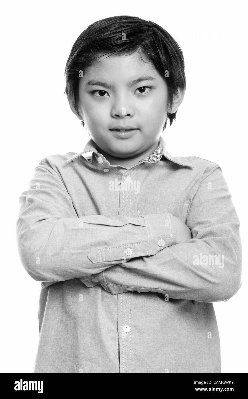 Studio shot of cute Japanese boy with arms crossed Stock Photo
