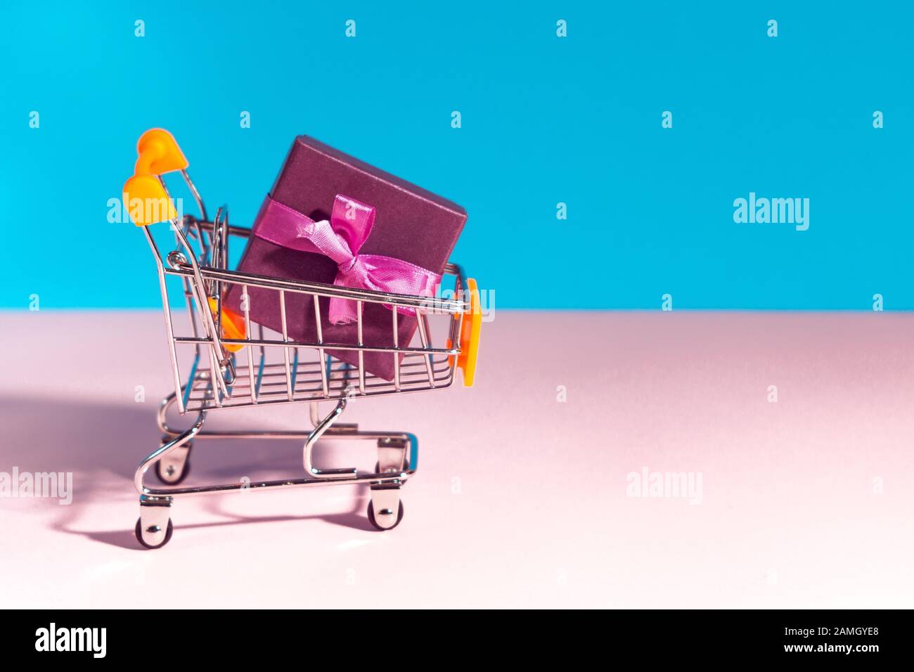 shopping cart. basket with bright gifts. the concept of gift shopping, space for text, copy space. Stock Photo