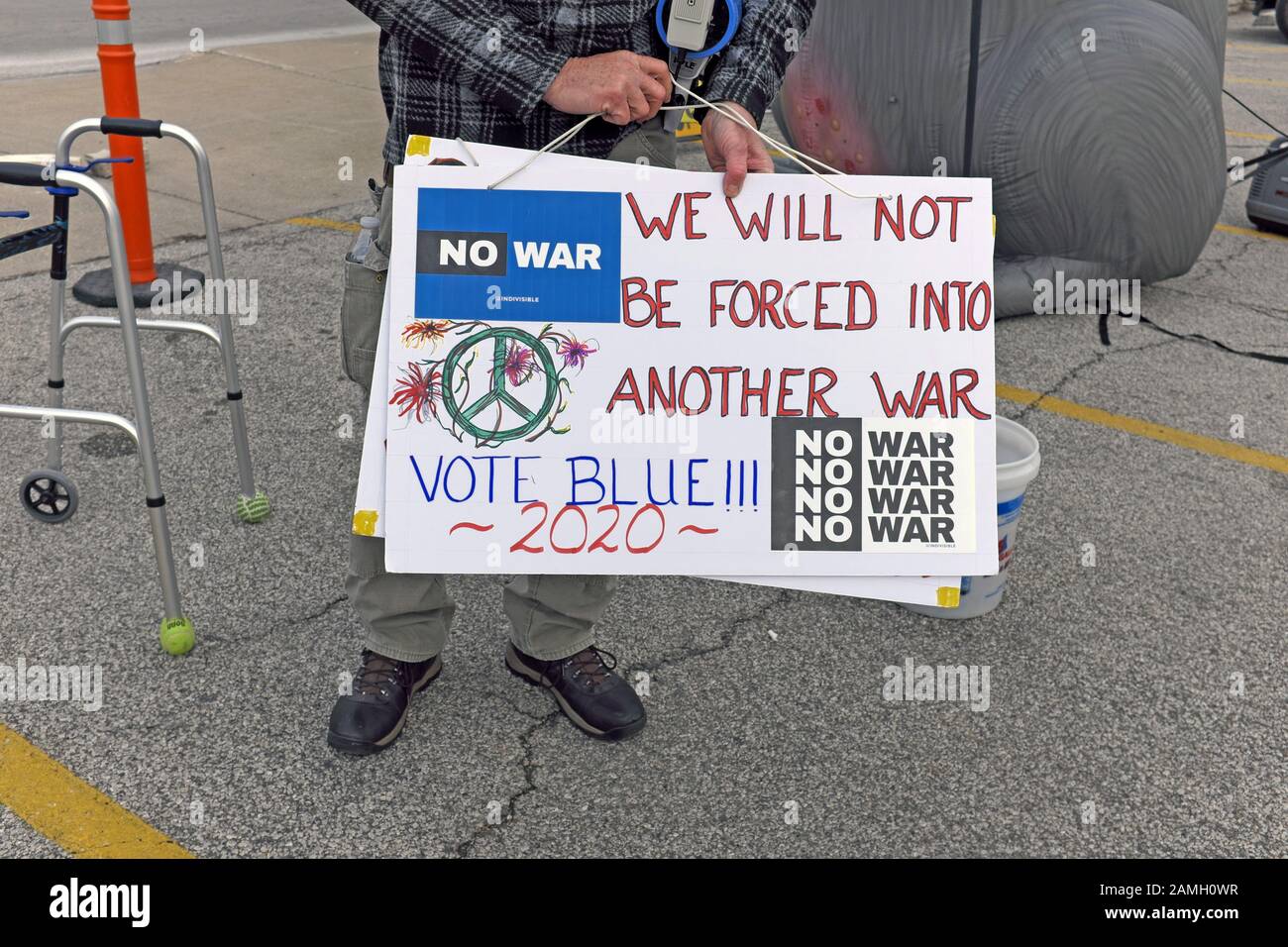An anti-GOP street protester holds a 'No War' sign in response to the attack in Iran.  'We will not be forced into another war vote Blue 2020' Stock Photo