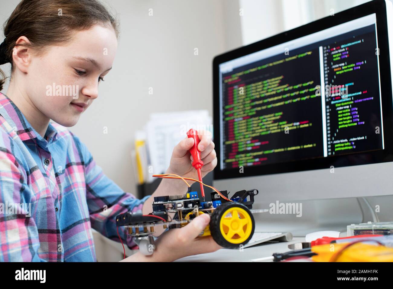 Female Pupil Building Robot Car In School Science Lesson Stock Photo