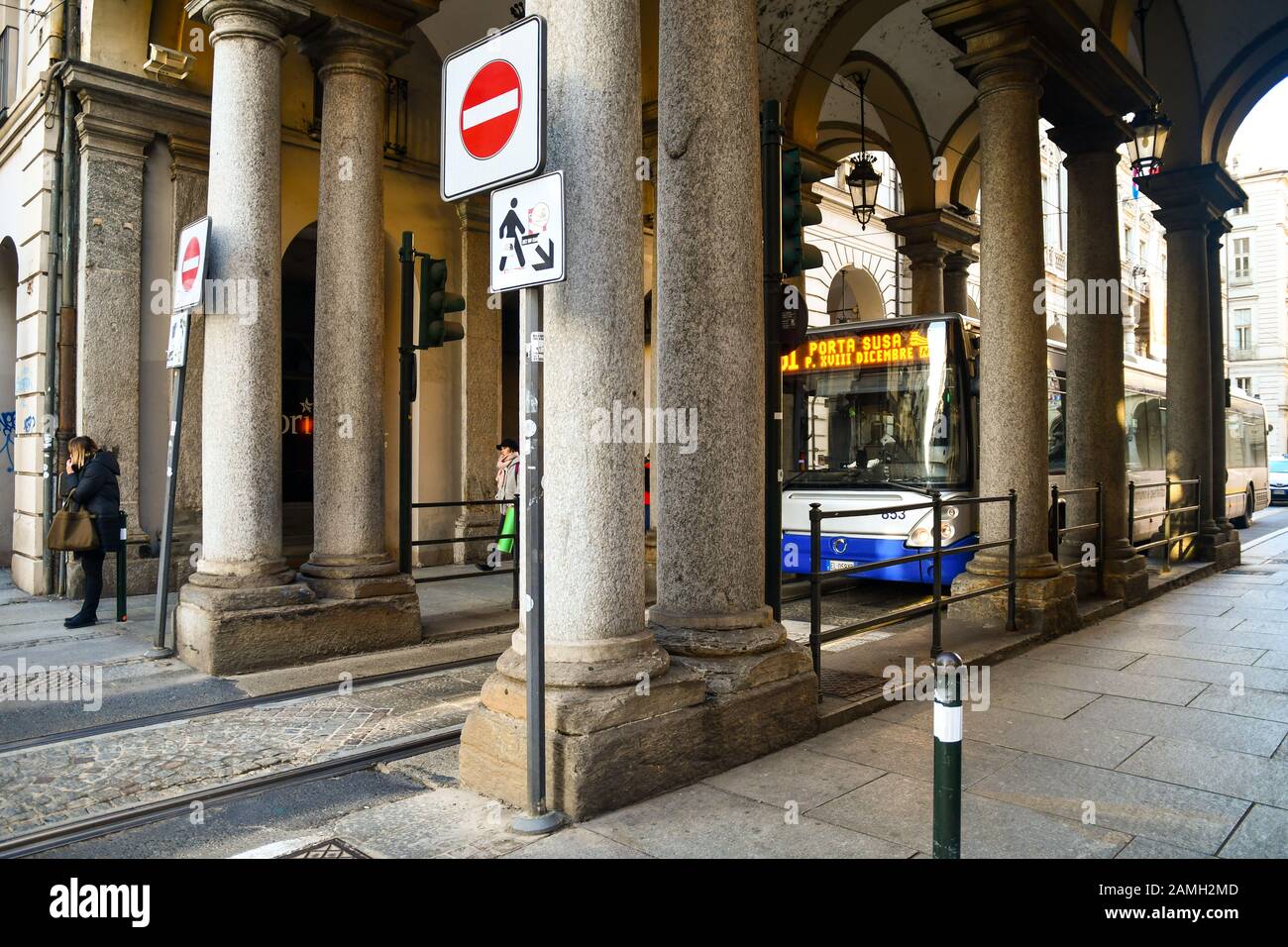 51 line bus passing under the arcade at the crossroads between Via Milano and Via Garibaldi streets in the city centre of Turin, Piedmont, Italy Stock Photo