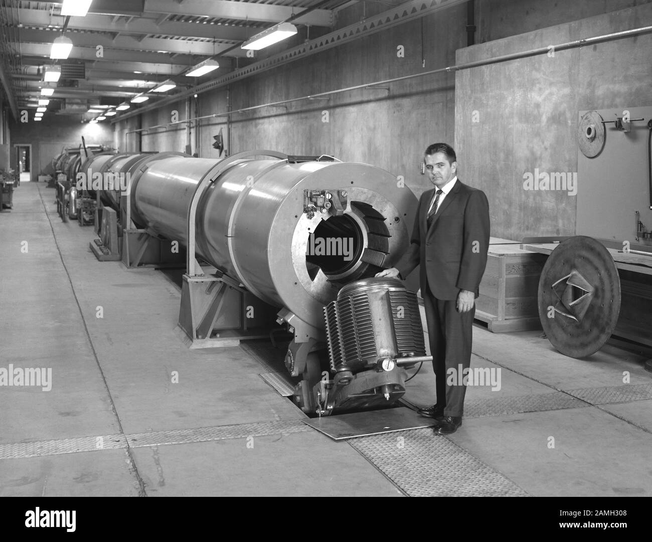 Branch Chief Thomas Canning standing beside a Hypersonic Free-Flight Aerodynamic Facility combustion-driven shock tube, the Ames Research Center, Mountain View, California, United States, 1966. Image courtesy NASA. () Stock Photo