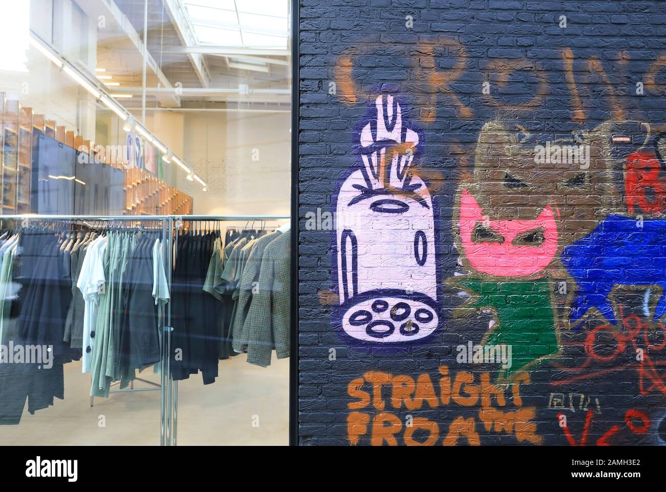 Colourful street art amongst the designer fashion shops on Kopstraatje off  Kammenstraat, in central Antwerp, Belgium north Europe Stock Photo - Alamy